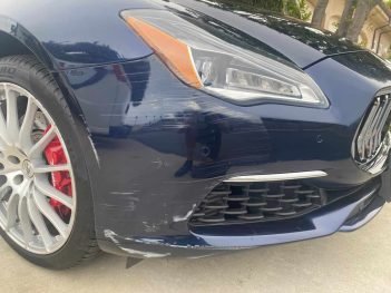 Scratches on a dark blue Maserati